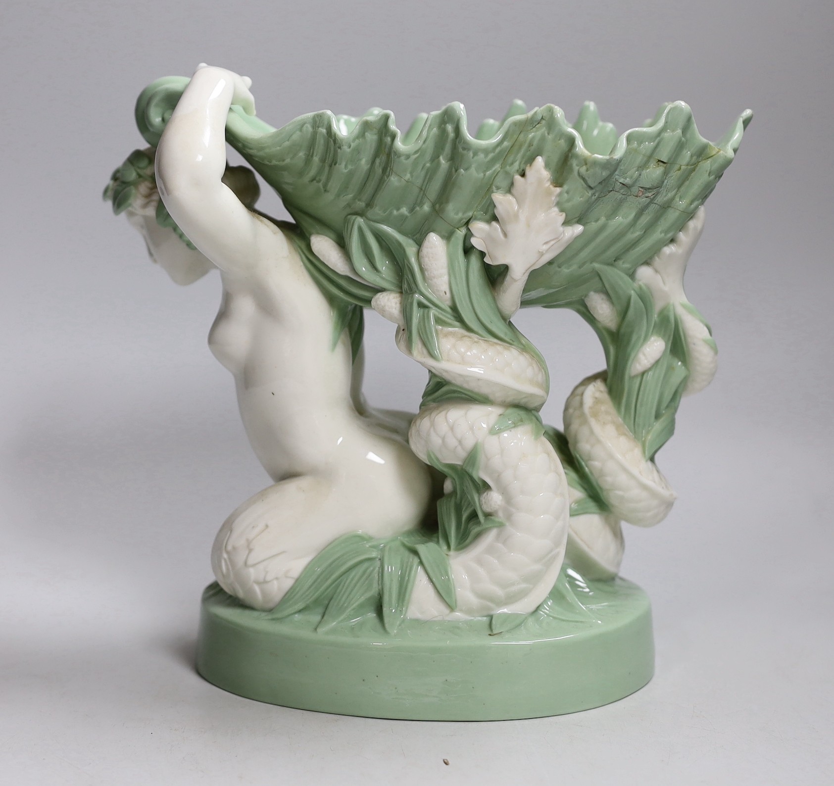 A 19th century Minton celadon glazed figure of a mermaid with a shell on her back, 21cm tall